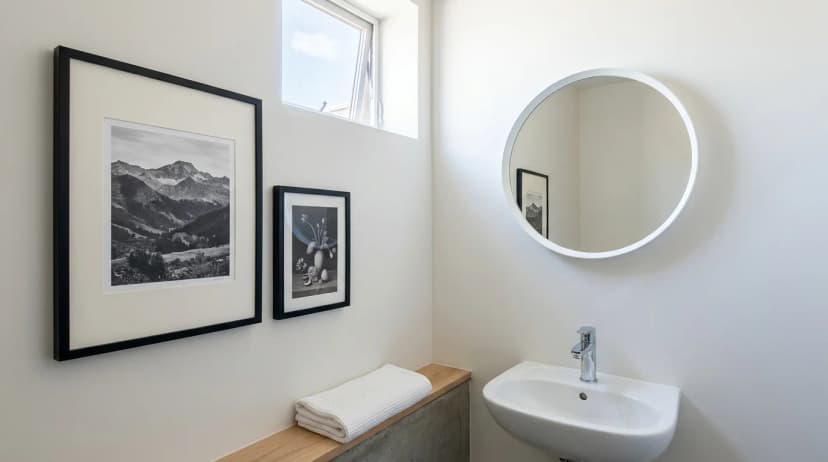 Dry, well-ventilated guest bathroom interior with two MDF frames without glass hung away from the shower zone