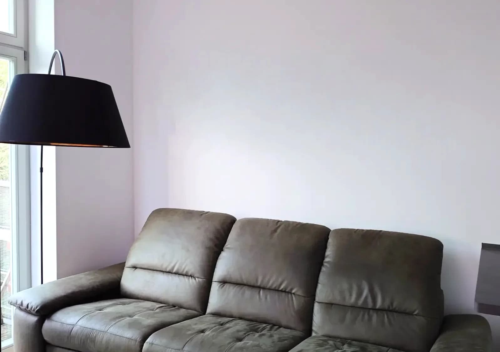Empty wall above couch before gallery
