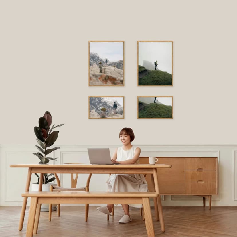 Gallery wall arranged in horizontal tiers with varied frame sizes within each row